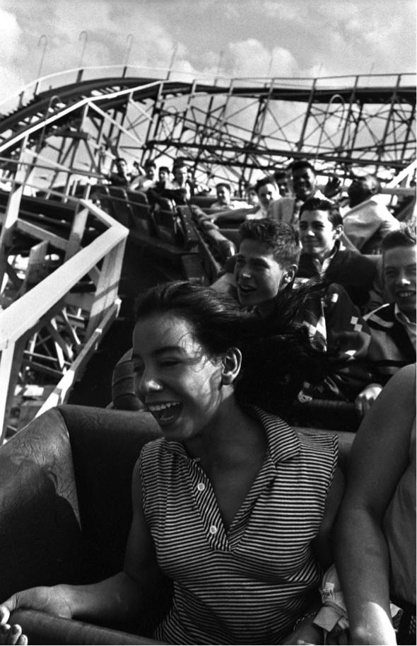 A black and white still of a woman on a rollercoaster
