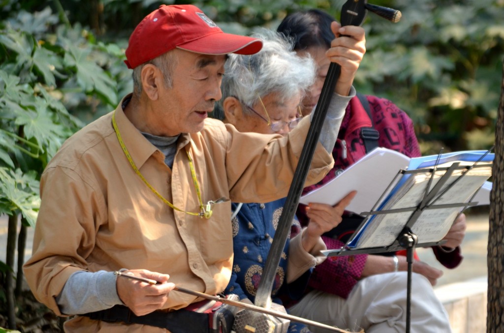 Chinese older people playing traditional music in urban park