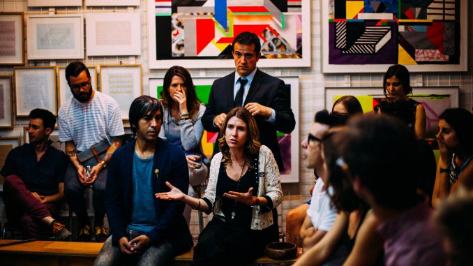 People meeting in a room, looking serious