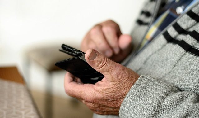 older person holding mobile phone