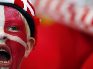 A young Denmark fan with his face painted in the colors of the Danish flag watch their men's handball Preliminaries Group B match against Croatia at the Copper Box venue during the London 2012 Olympic Games