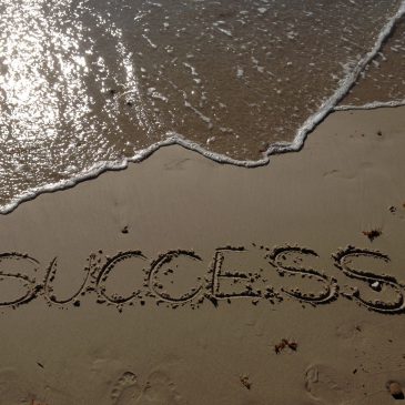 The word "success" written on the sand
