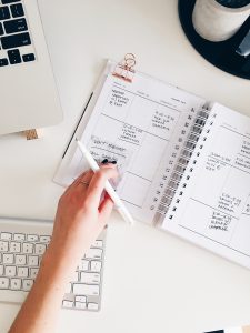 Image of person writing in a planner