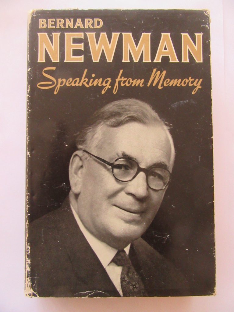The front cover of Bernard Newman's autobiography on a plain background. It is a black cover with a photograph bust portrait of Bernard, a middle-aged man with short grey hair and black glasses.