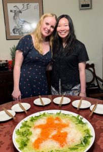 Emmie and a friend on Lunar New Year with a plateful of food