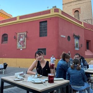 HInano sitting outside  in a restaurant