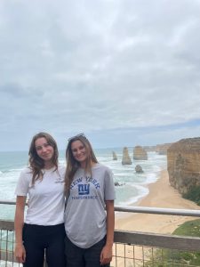 Two females standing in front of the 12 Apostles, Great Ocean Road, Australia