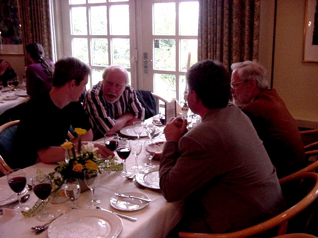 Sitting at a dinner table, chatting, are (from left to right): Michael Kölling, Niklaus Wirth, Michael E Caspersen, David Gries