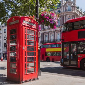 A red telephone box and London bus on a street corner