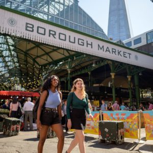 Two students walking through Borough Market