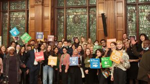 Group picture at the London Student Sustainability Conference with participants holding up SDG signs
