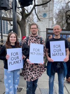  3 people holding up banners