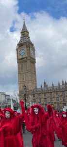 Big ben and parade of people wearing red costumes