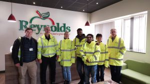 Group of students and staff wearing hi vis vests in the Reynolds office. 